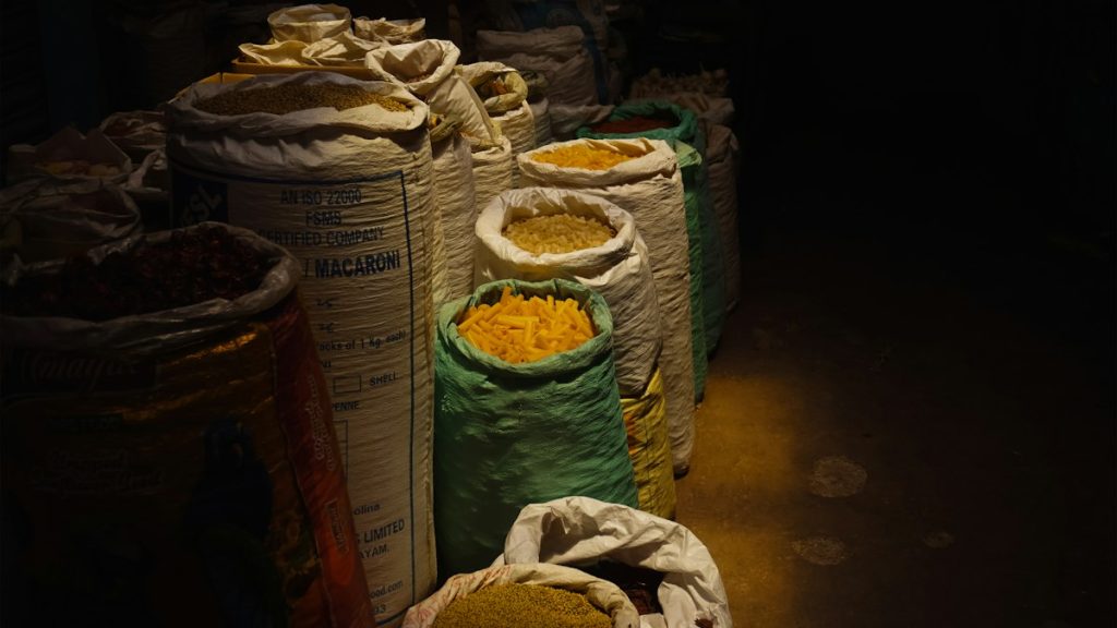 Filled sacks stacked in a storage warehouse